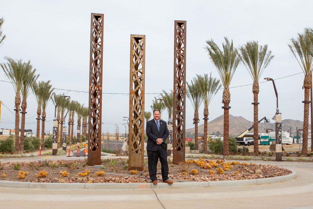 Photo of Eastvale City Manager in front of new construction