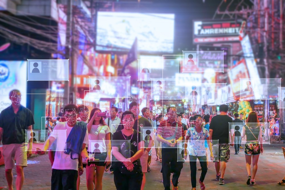 Photo of crowded city street with facial recognition software in use