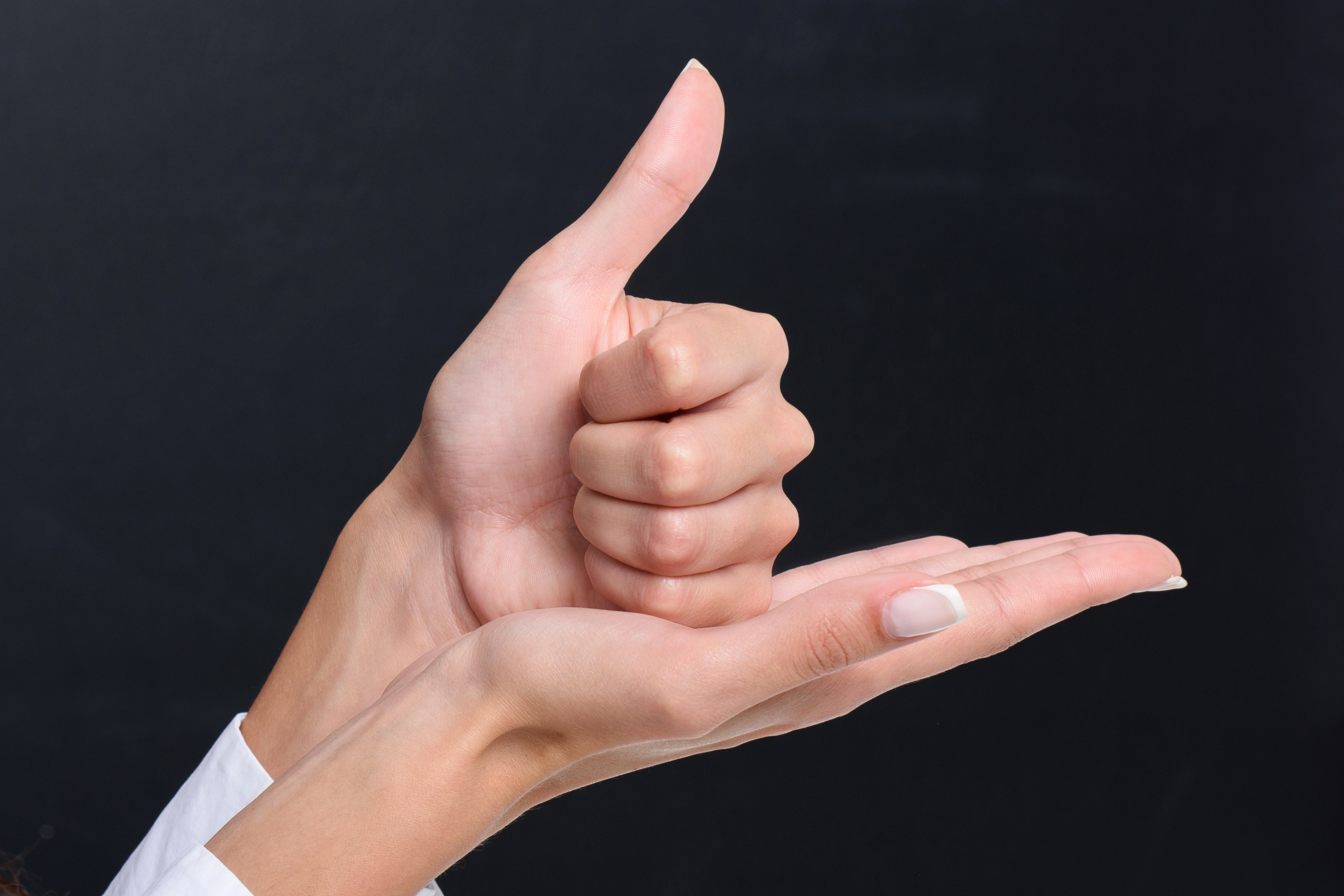 Hands conveying "help" in sign language