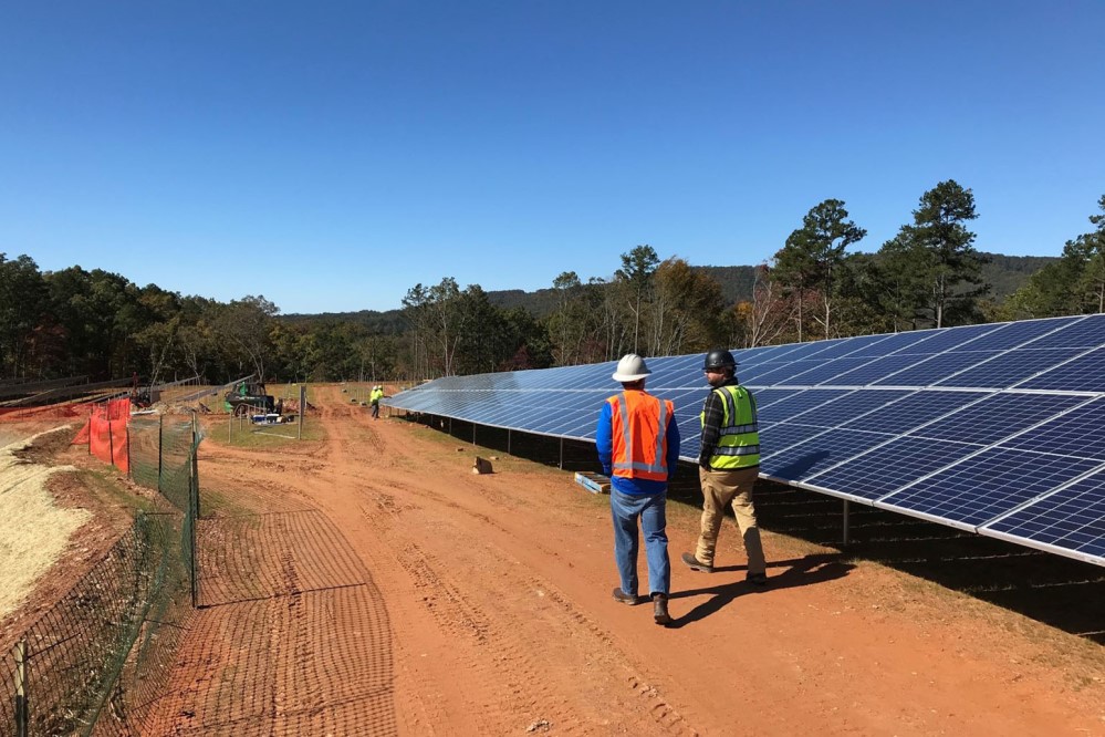 Photo of workers installing solar panels