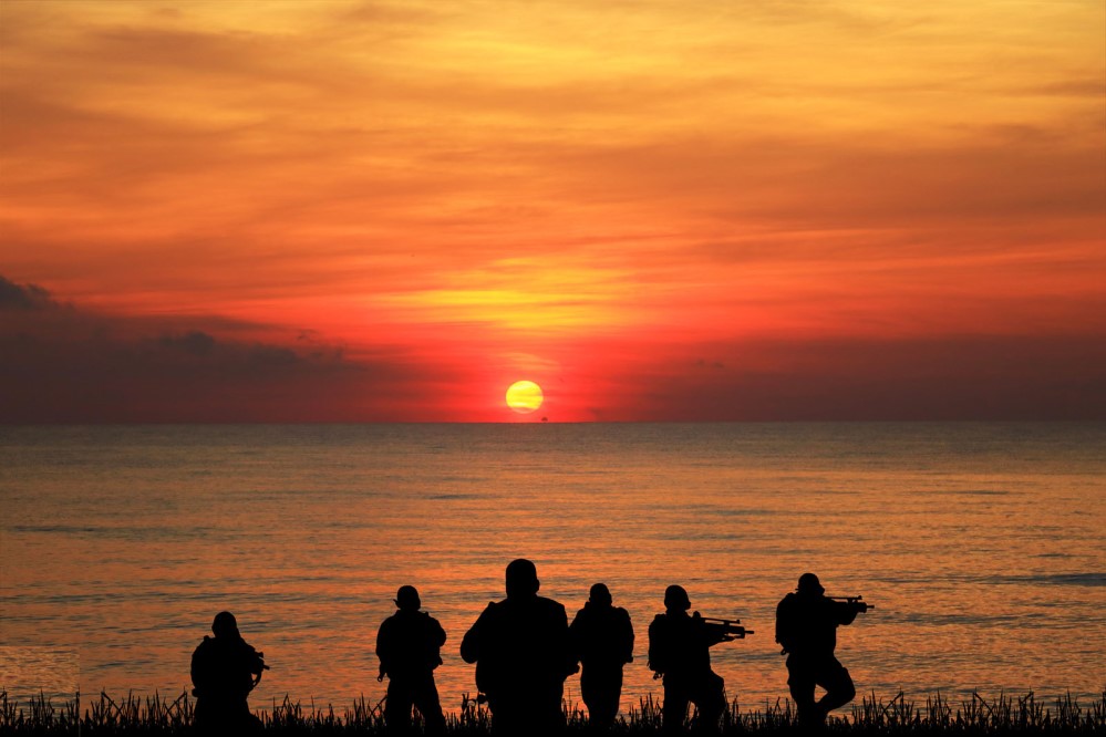 Navy seals in front of sunset