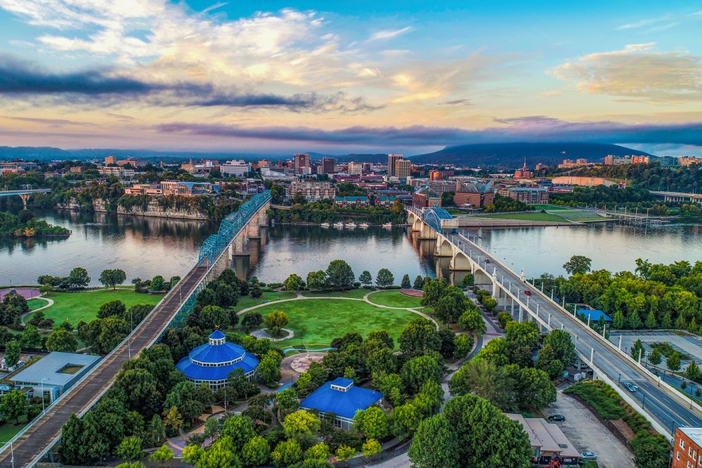 Image of bridges over a river amidst a city skyline