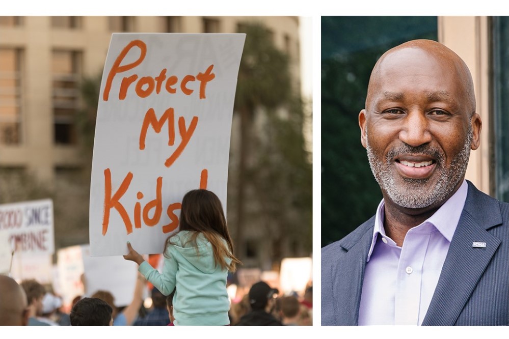 Image of child holding sign reading 'Protect My Kids'