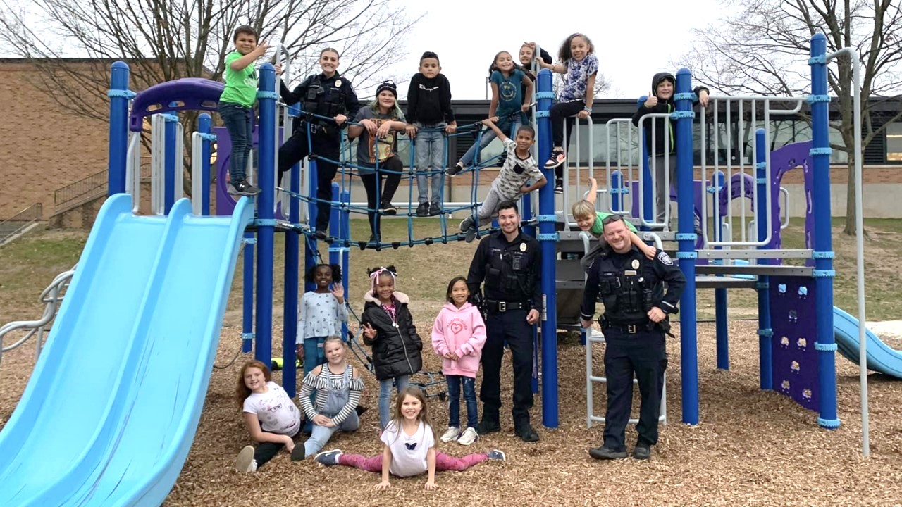 Photo of police officers and children on playground