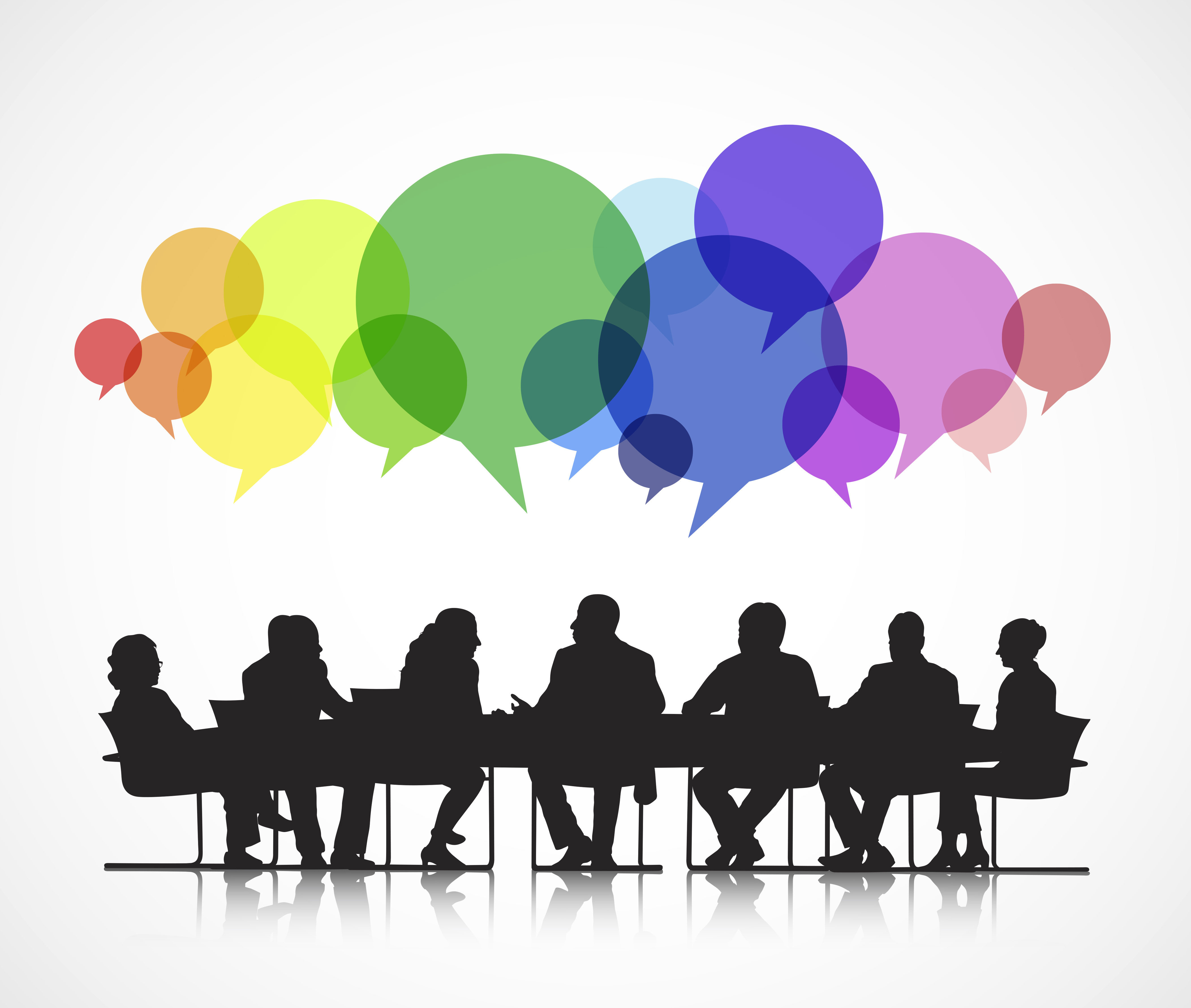 People talking around table with colored speech bubbles