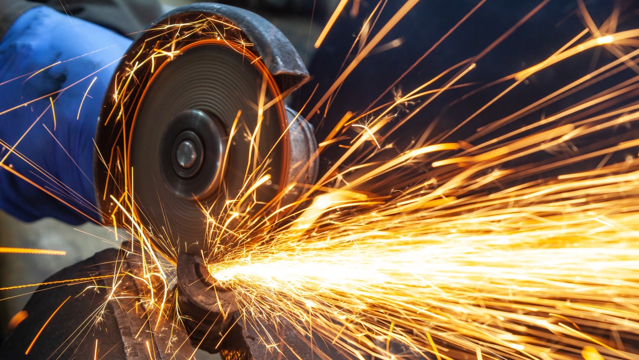 Close-up of bright sparks from an angle grinder machine