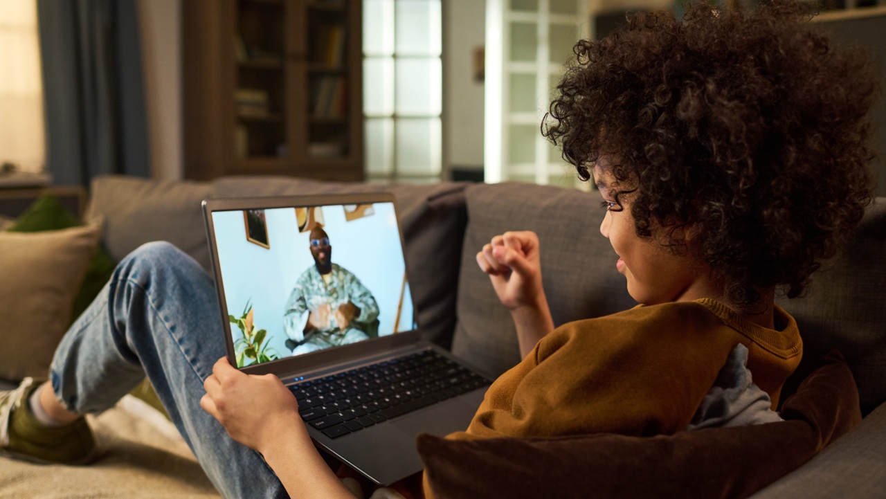 Image of child on video call with military parent