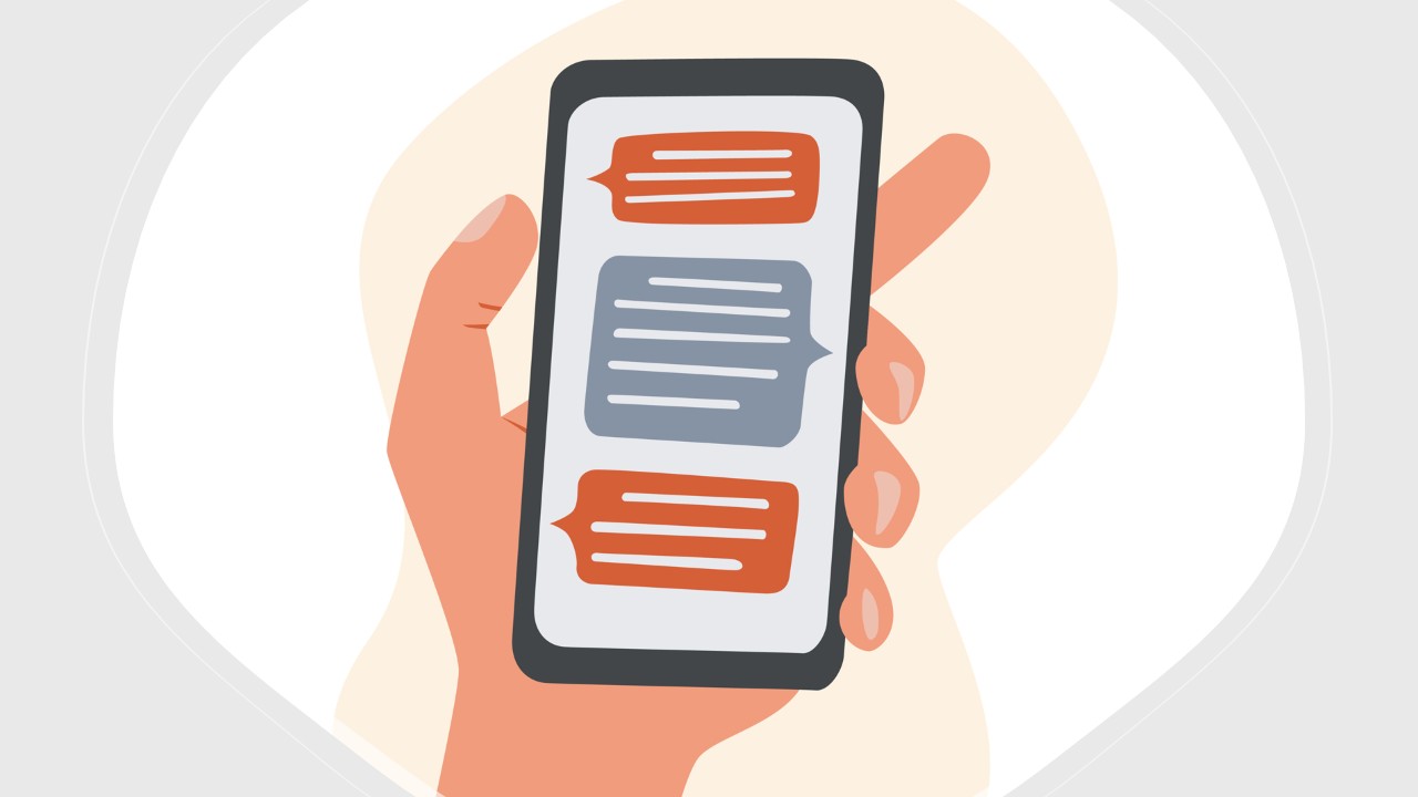 Image of hand holding a smartphone with text conversation visible