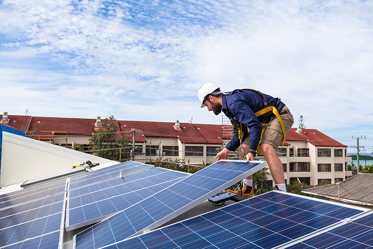 Photo of a solar panel technician