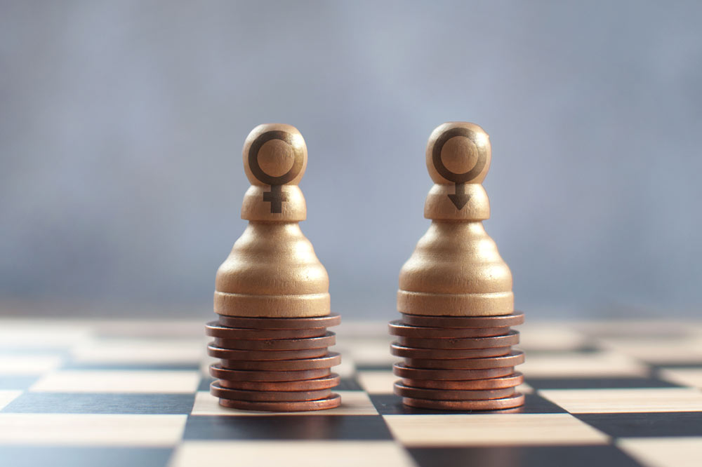Equal gender pay, two chess pawns on top of two equal stacks of pennies