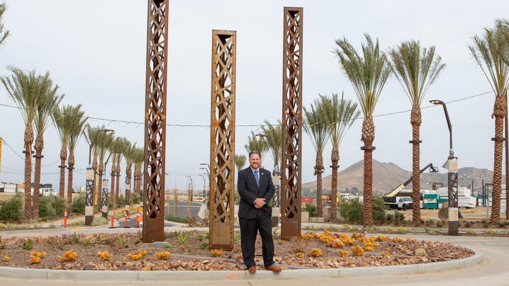 Photo of Eastvale City Manager in front of new construction