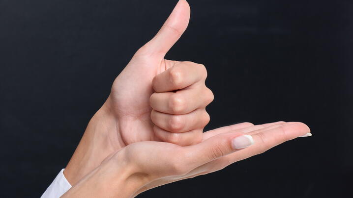 Hands conveying "help" in sign language