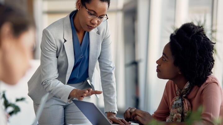 An image of people having a discussion in an office