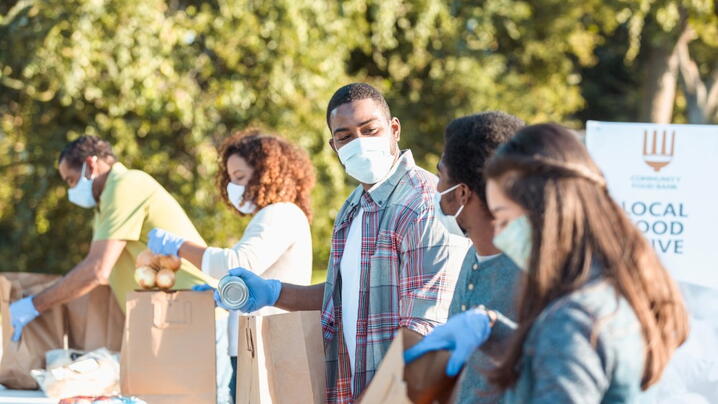 Stock photo of volunteers packaging food