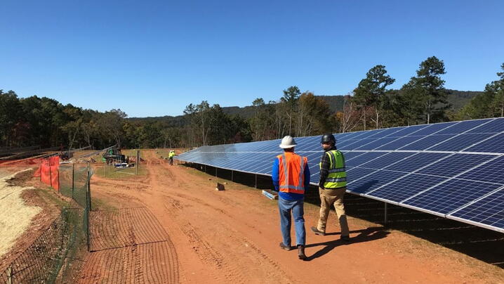 Photo of workers installing solar panels