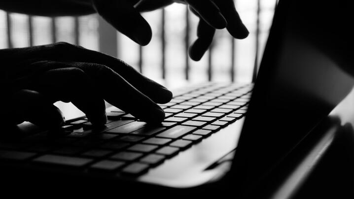 Photo of hands typing on a laptop