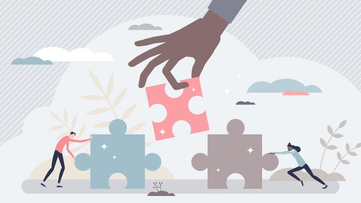 vector graphic with people fitting jigsaw puzzle pieces together to demonstrate collaboration, teamwork and work support for problem solving