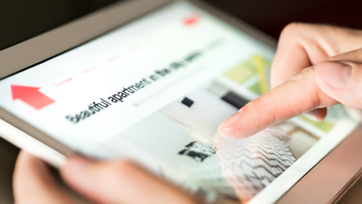 person searching vacation rental online with tablet