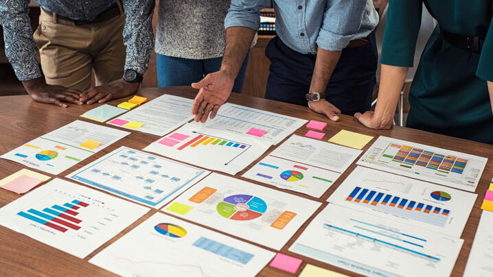 Business casual team working on graphs