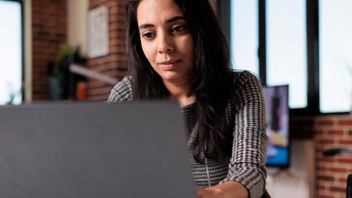 Woman looking at laptop