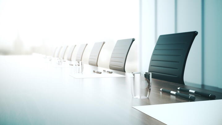 Image of a board room table and chairs