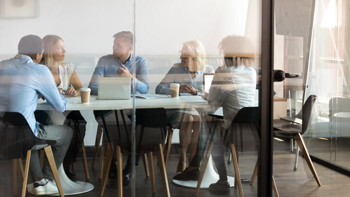 Image of people at a conference room table