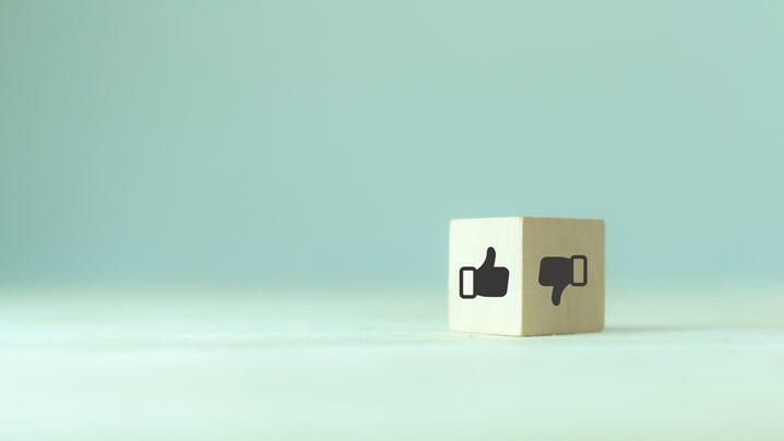 Image of a cube with a thumbs up and thumbs down