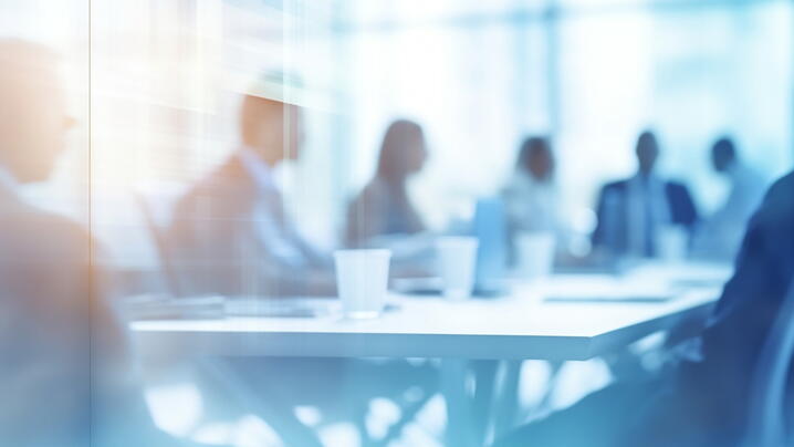 Image of people at a conference room table