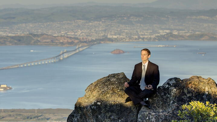Photo of author meditating above scenic view