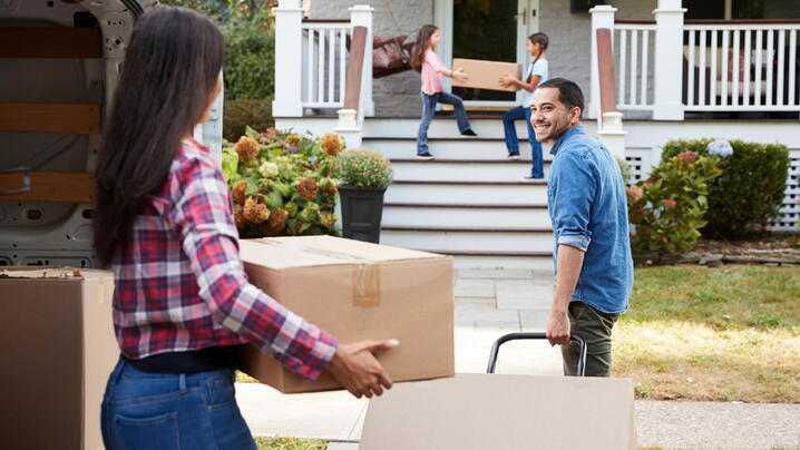 Image of family moving into a house