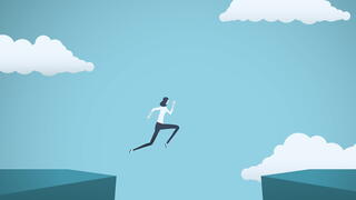 Image of business person jumping from one cliff to another
