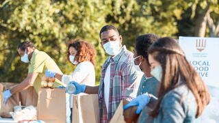 Stock photo of volunteers packaging food