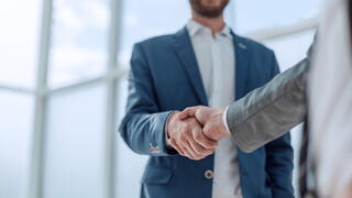 Image of two men shaking hands