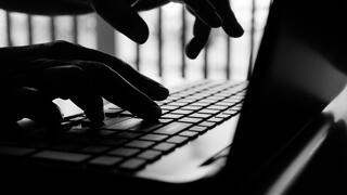 Photo of hands typing on a laptop