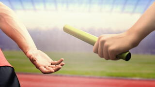 Image of two people passing a baton in a race