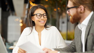 Photo of a woman and a man talking