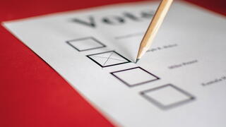 Close-up photo of pencil checking box on Voting ballot paper