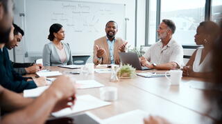 Image of manager and staff around table