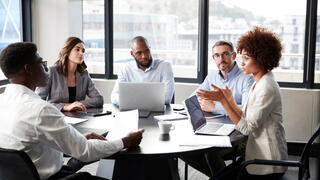 Image of people at a conference room table