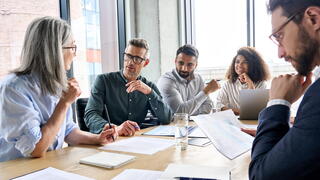 Image of people at a conference room table