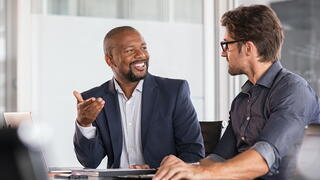 Image of two people talking