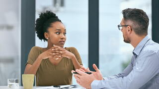 Image of two people talking