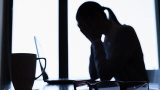 Silhouette of person crying