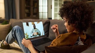 Image of child on video call with military parent