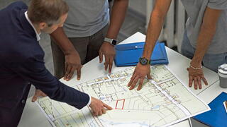 Image of men looking at neighborhood map
