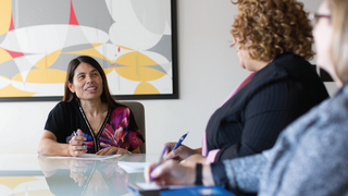 women around meeting table